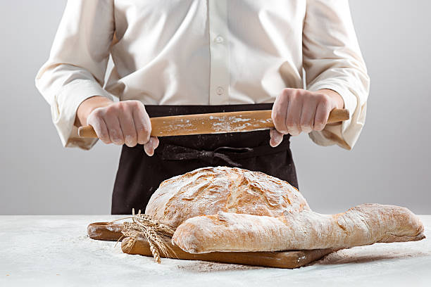 istock The male hands and rustic organic loaf of bread 637890564