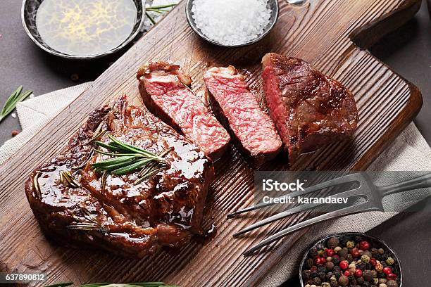 Grilled Ribeye Beef Steak Herbs And Spices Stock Photo - Download Image Now - Barbecue - Meal, Cutting Board, Filet Mignon