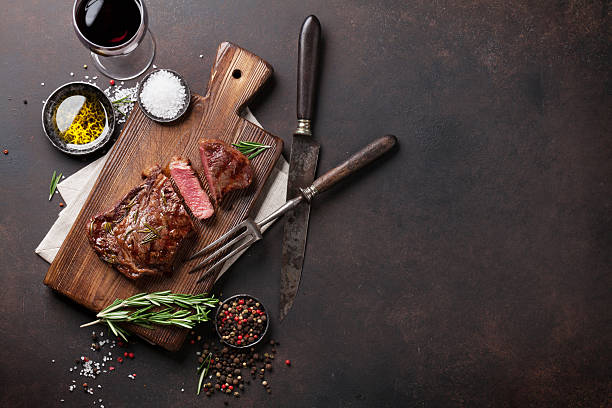 istock Grilled ribeye beef steak with red wine, herbs and spices 637890932