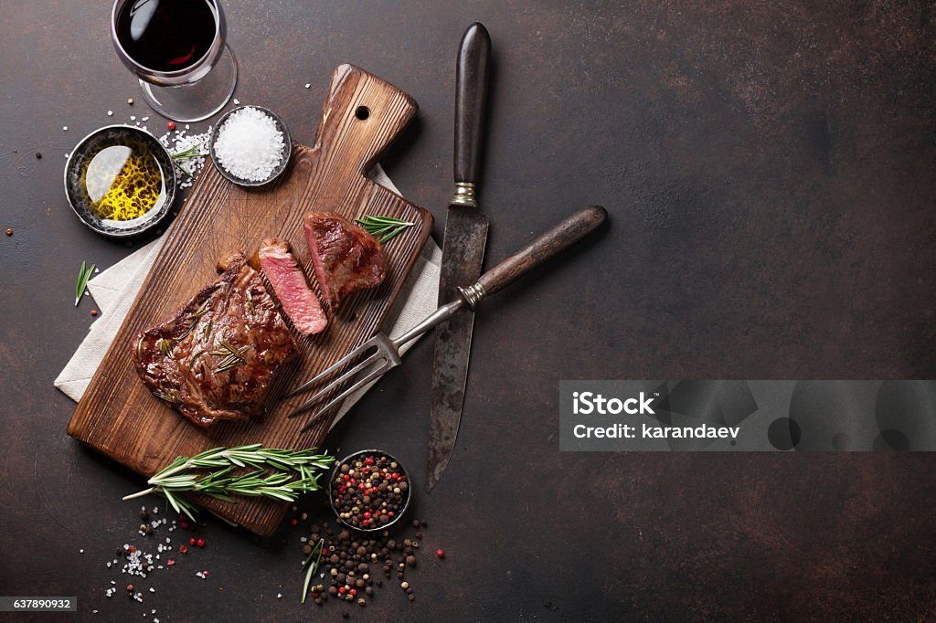 Grilled ribeye beef steak with red wine, herbs and spices Grilled ribeye beef steak with red wine, herbs and spices. Top view with copy space for your text Steak Stock Photo