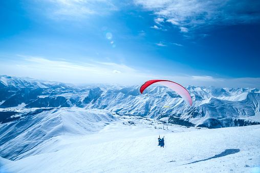 Winter in Greater Caucasus Mountains. Georgia (country). Gudauri ski resort. ParaglidingWinter in Greater Caucasus Mountains. Georgia (country). Gudauri ski resort. Paragliding