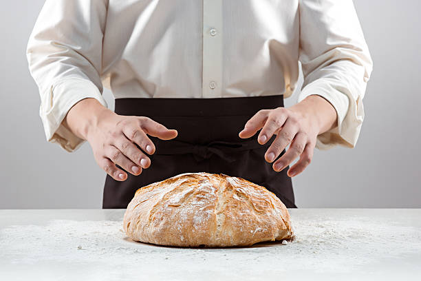 istock The male hands and rustic organic loaf of bread 637893748