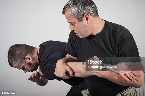 Kapap Instructor Demonstrates Arm Bar Techniques Stock Photo - Download Image Now - Self-Defense, Sports Training, Krav Maga