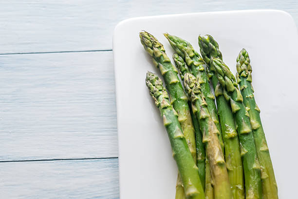 istock Bunch of cooked asparagus on the plate 637898758