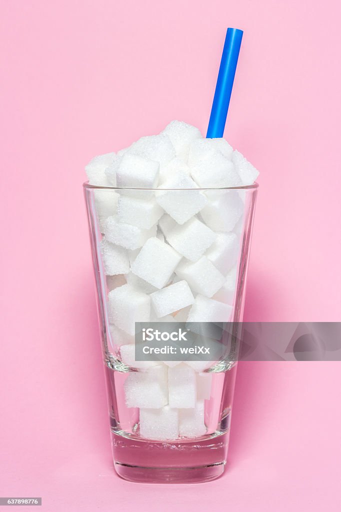 Glass full of sugar cubes - unhealthy diet concept. Glass full of sugar cubes - unhealthy diet concept Carbohydrate - Food Type Stock Photo