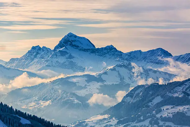 Beautiful winter landscape in the Mont Blanc Massif with the view to the Chaine des Aravis above the clouds and villages.