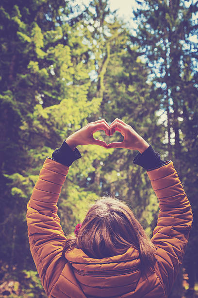istock Girl making a heart-shape outdoors. 637900500