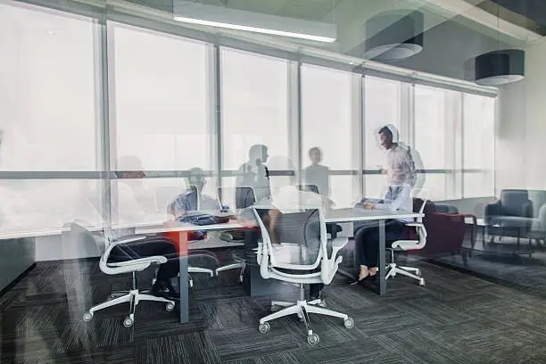 Reflections of business colleagues having meeting in office