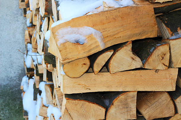 istock Stacked firewood in winter under the snow 637901188