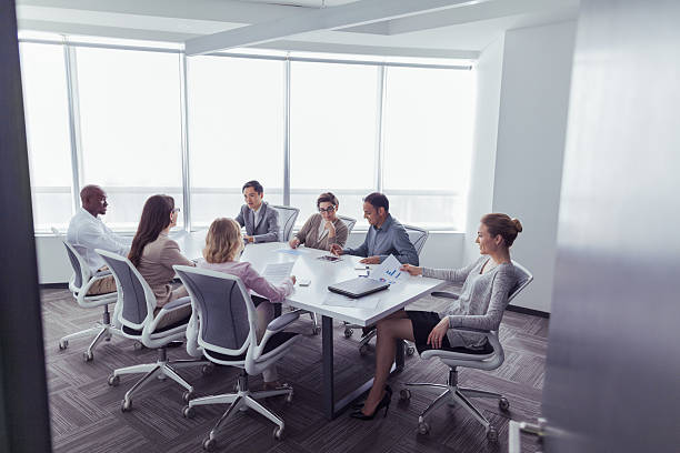 Group business meeting in office conference room Group business meeting in office conference room arthurian legend stock pictures, royalty-free photos & images
