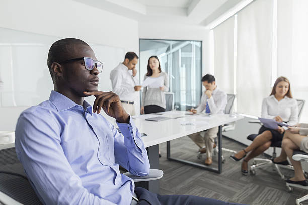 Businessman thinking during meeting in office