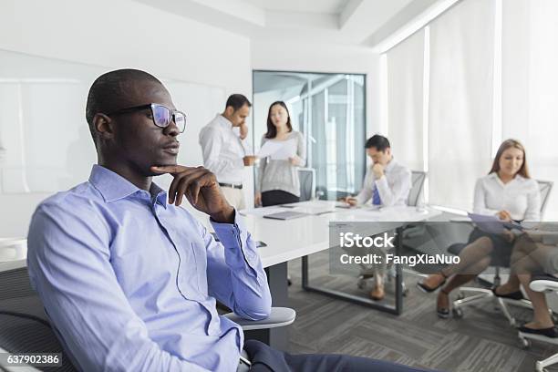 Businessman Thinking During Meeting In Office Stock Photo - Download Image Now - Shy, Contemplation, Business