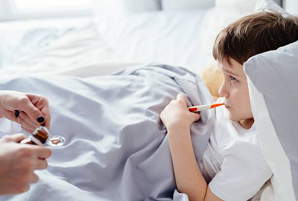 istock Doctor giving sick child a syrup 637904664