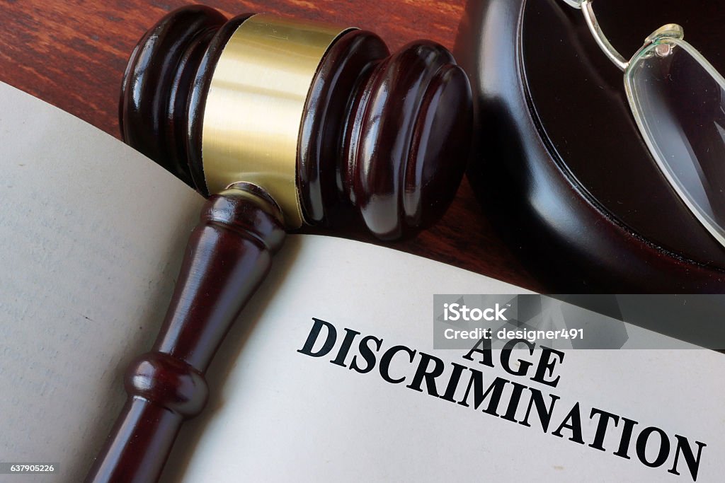 Book with chapter age discrimination and a gavel. Prejudice Stock Photo
