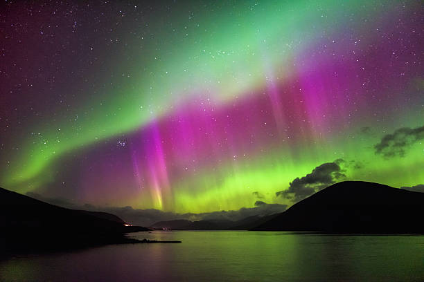 Aurora Borealis - Northern lights, Garve, highlands Scotland Aurora Borealis, also known as the Northern loights, putting a show on dancing over Loch Glascarnoch, by Garve, Highlands of Scotland, UK. aurora borealis stock pictures, royalty-free photos & images