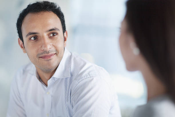 istock Young man looking at colleague in office 637910764