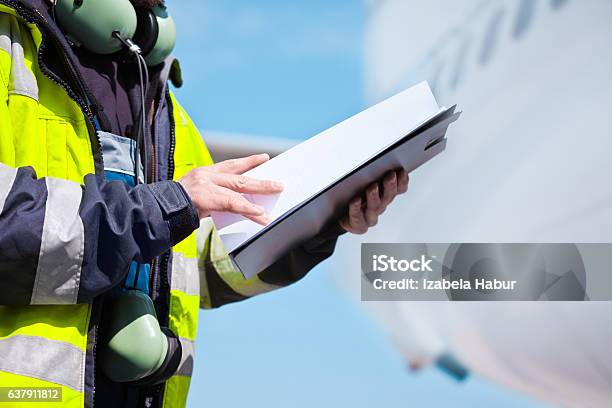 Ground Crew In Front Of Airplane Stock Photo - Download Image Now - Airport, Air Vehicle, Safety