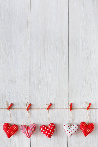 istock Valentine day background, pillow hearts border on wood, copy space 637911958