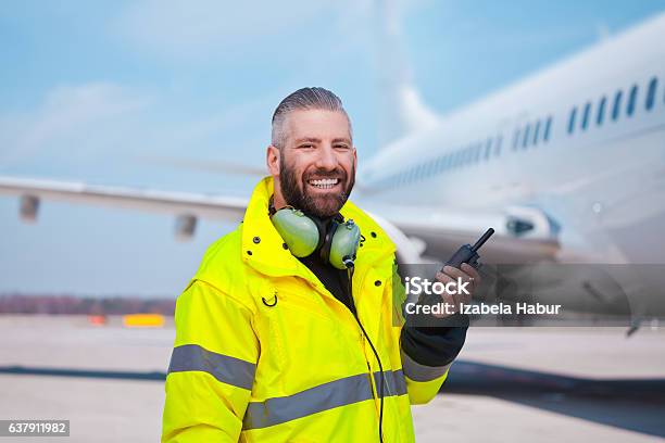 Ground Crew Using Walkietalkie Outdoor In Front Of Aircraft Stock Photo - Download Image Now