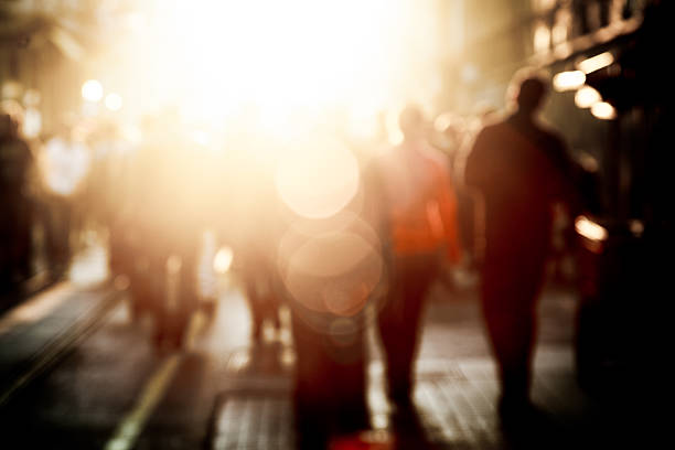 Crowded pedestrian walking on Istiklal street on sunny day with sunflare in Taksim, Beyoğlu, Istanbul, Turkey
