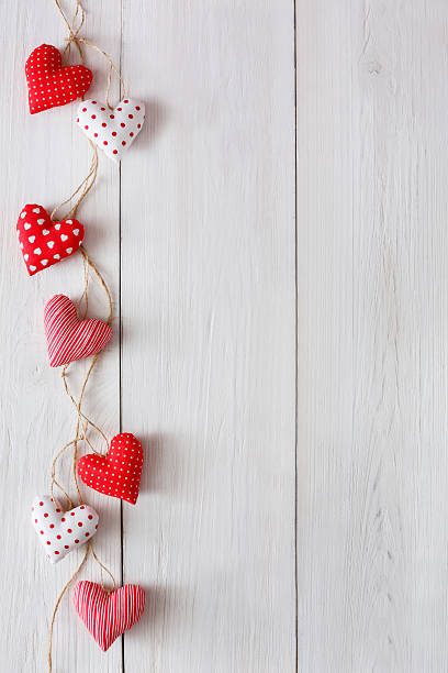 istock Valentine day background, pillow hearts border on wood, copy space 637912030