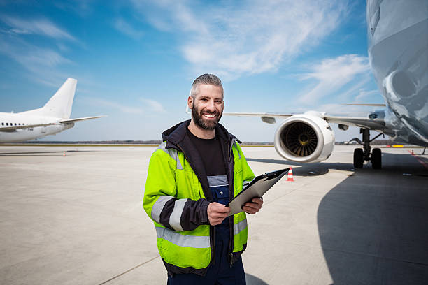 aircraft worker in front of airplane with checklist - ground crew audio imagens e fotografias de stock