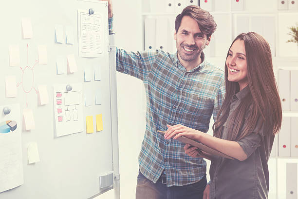 istock Man and woman are smiling and making a presentation 637914786