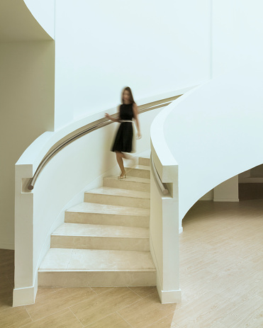 Blurred woman walking down staircase