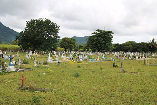 Olivia, Mauritius - December 4, 2016: Cemetery with many graves in a green environment during a cloudy and rainy day.