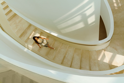 View of woman descending staircase in modern building