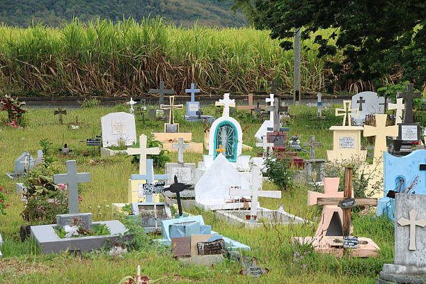 Olivia, Mauritius - December 4, 2016: Cemetery with many graves in a green environment during a cloudy and rainy day.