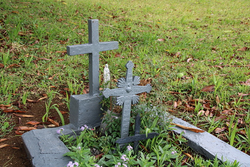Olivia, Mauritius - December 4, 2016: Cemetery with many graves in a green environment during a cloudy and rainy day.