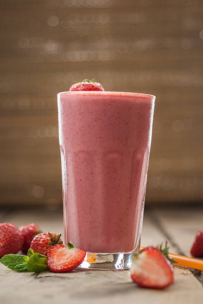 istock Strawberry smoothie on wooden background 637917688