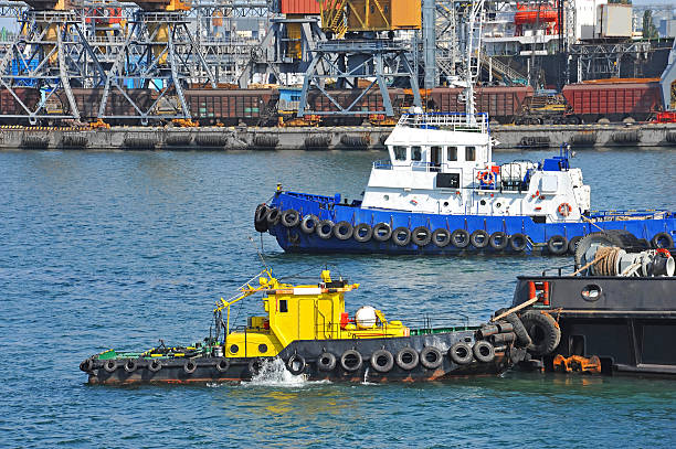 istock Tugboat and port cargo crane 637918118