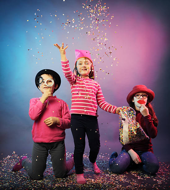 funny carnival portrait three little girls in carnival masks having fun carnival children stock pictures, royalty-free photos & images