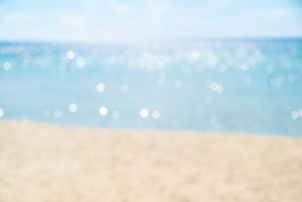 istock blurred sea blue sky and white sand, sea with bokeh 637920314
