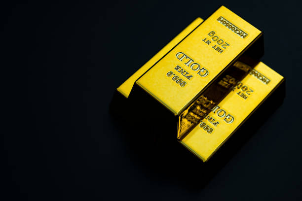 istock three pieces of gold bar stack up on black background 637921000