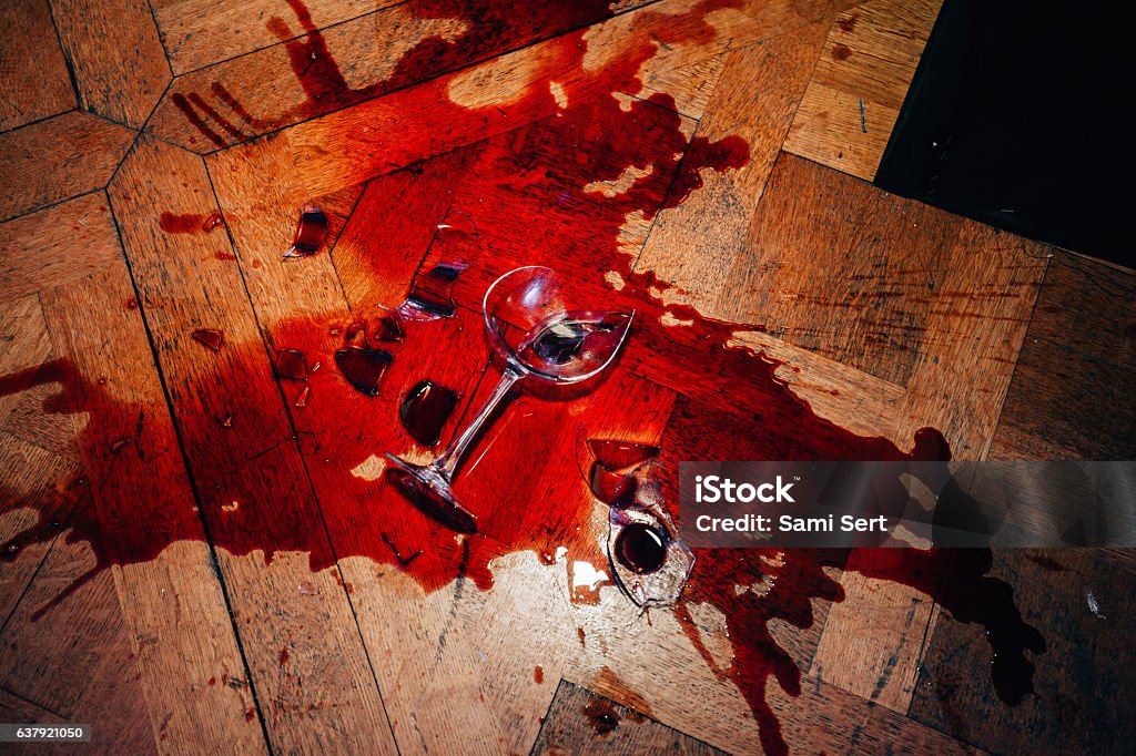 Broken red wine glass Broken glasses of red wine splashed on hardwood parquet floor Wine Stock Photo