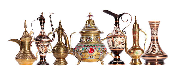 Copper jug with a traditional Arabic ornaments on a white background