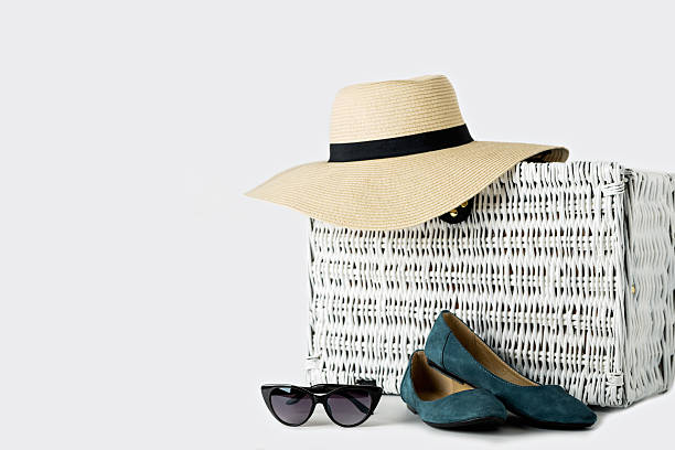 istock White wicker suitcase, women's hat, glasses and blue shoes. 637922448