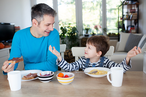 Father and son having breakfast at home