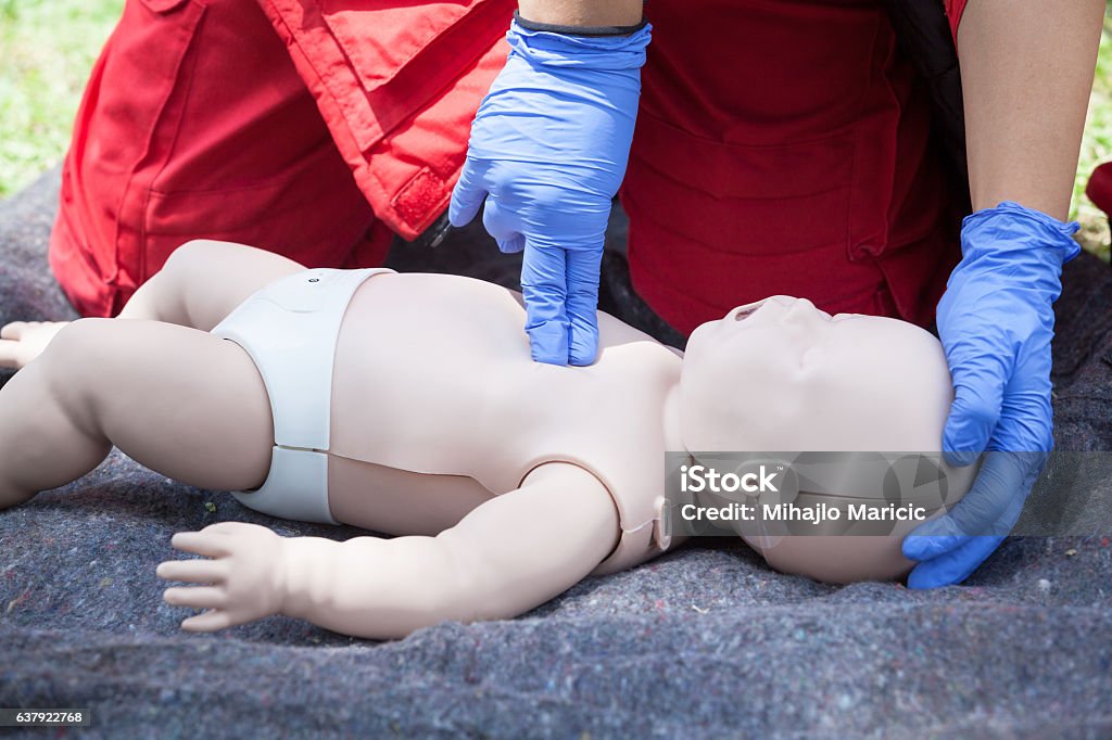 Baby CPR dummy first aid training. Heart massage. Cardiopulmonary resuscitation. Cardiac massage. CPR Stock Photo