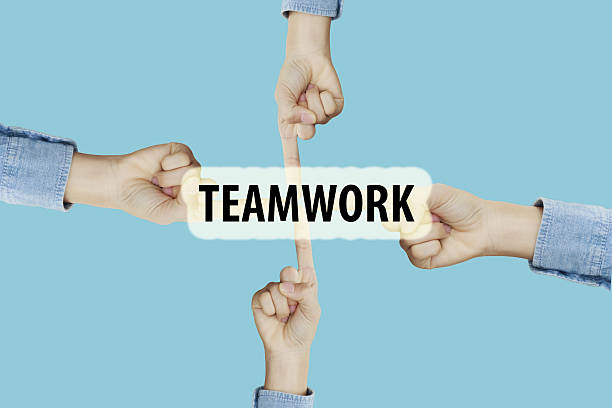istock Many hands fingers pointing with index fingers to TEAMWORK text 637923428