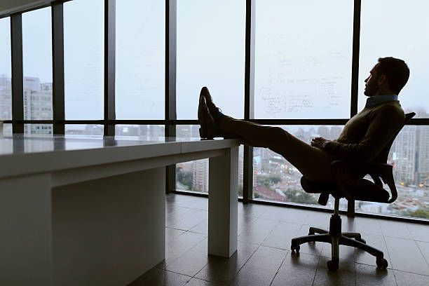 istock Man with feet propped up on table in meeting room 637923824