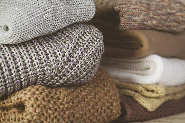 istock tinted image two stacks of warm sweaters on the table 637924118