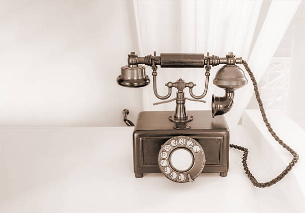 istock Ancient phone is placed on a wooden table, vintage style. 637924828