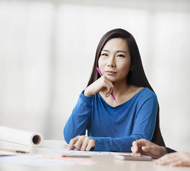 Woman sitting and thinking in design studio office