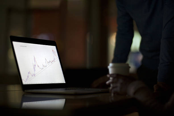 Laptop screen with graph diagram in office