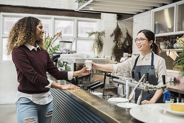 istock Young woman serving female customer in cafe 637926254
