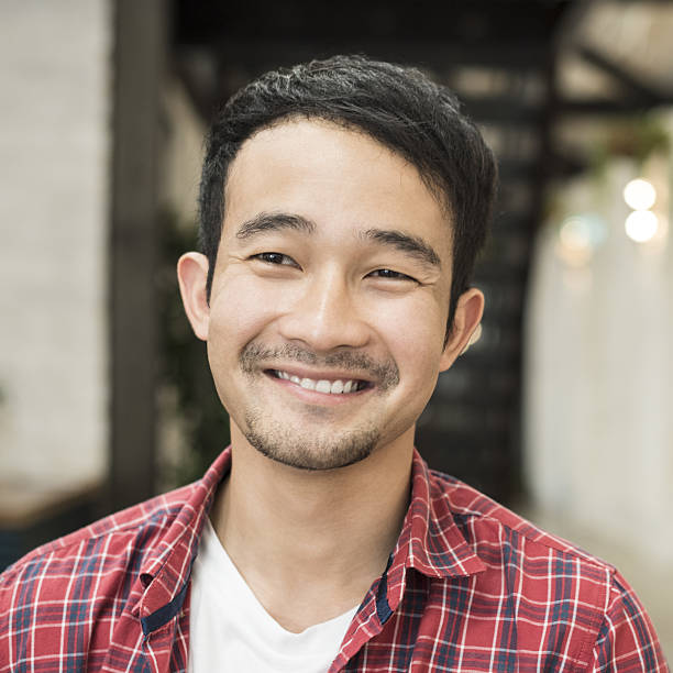 istock Cheerful young Asian man smiling and looking away 637926752